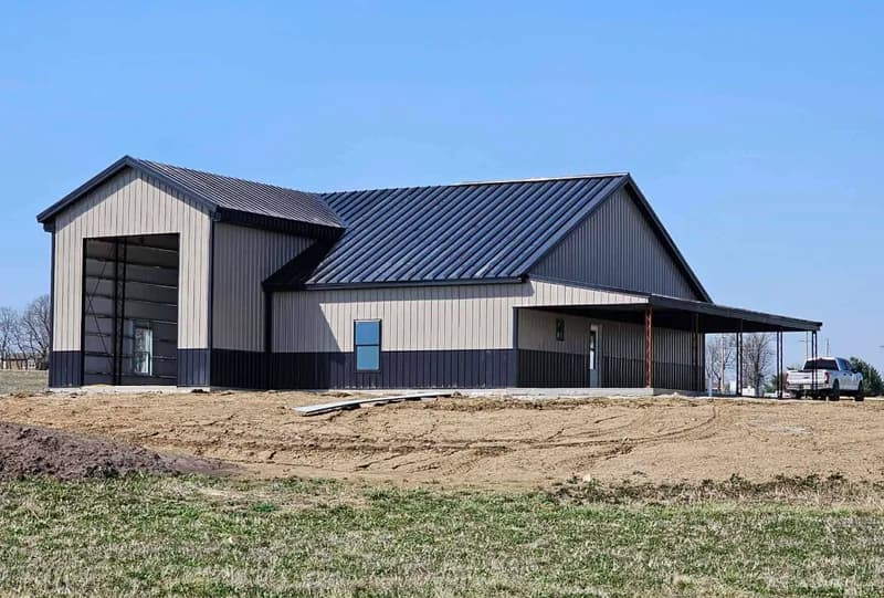 Steel building with a metal roof and covered lean-to
